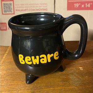 Black Cauldron Mug with Yellow 'Beware' Text